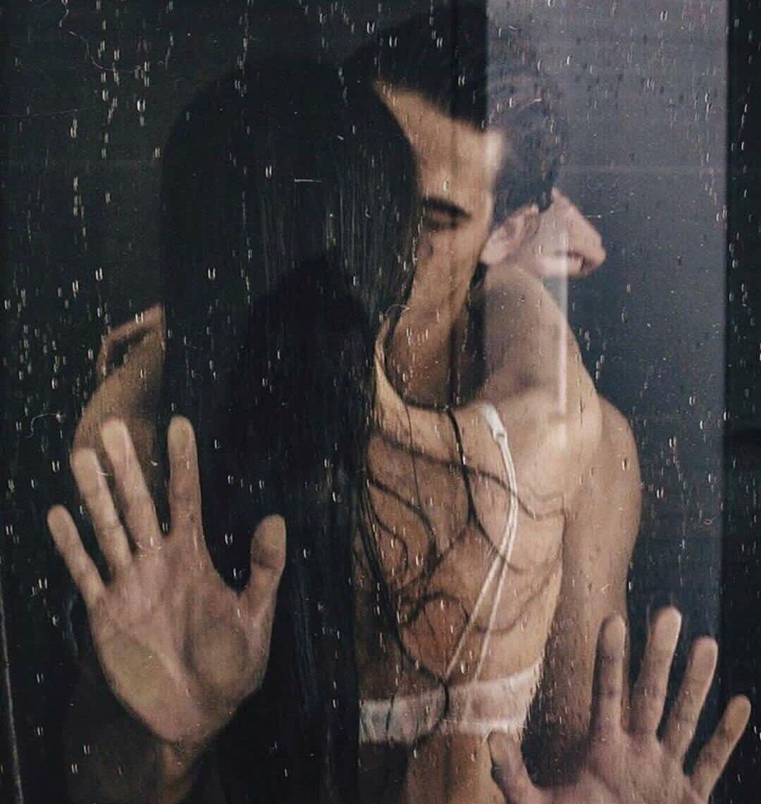Жена прислонила зад к мокрому стеклу в душе. фото